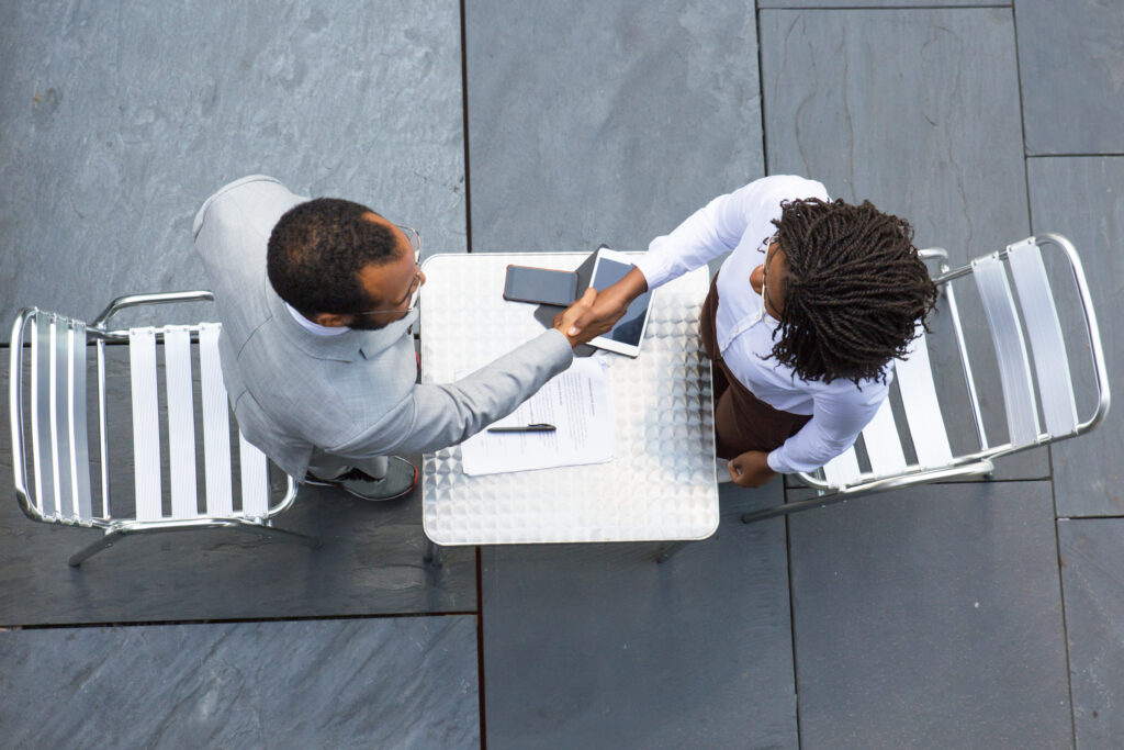 M&A advisors closing a successful small business acquisition deal for a client in a specialized industry.